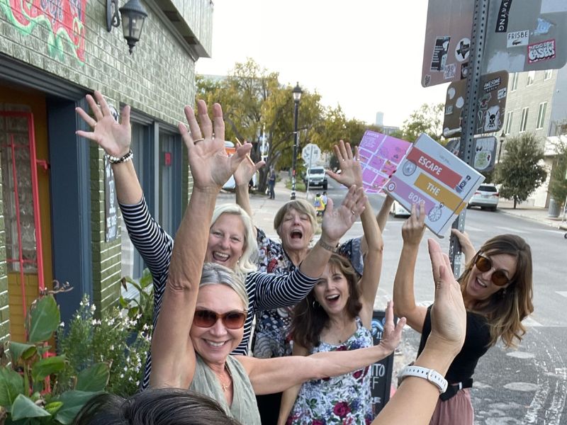 Employees playing Escape the Box, an outdoor escape game, in Austin, TX