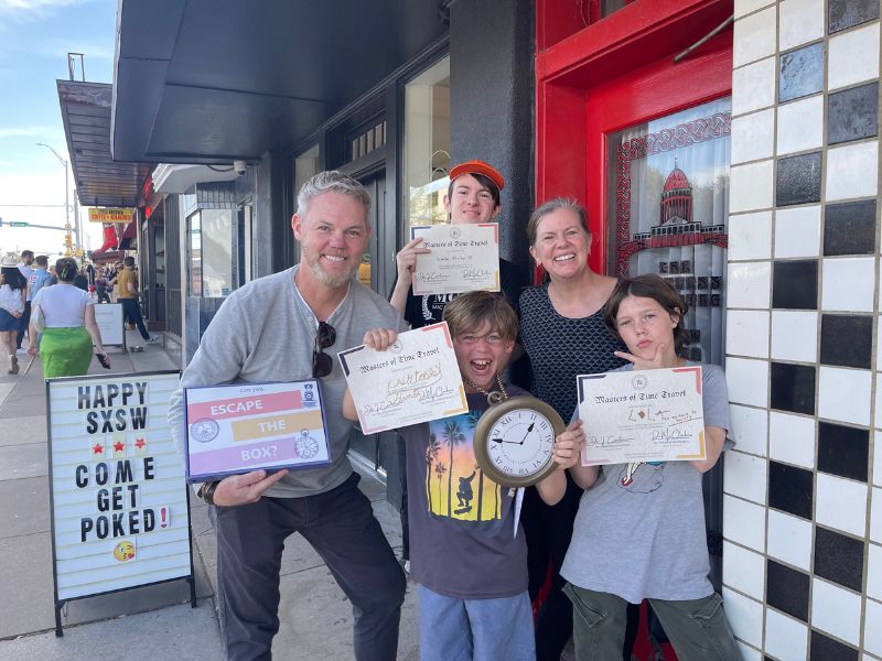 Family playing Escape the Box, an outdoor escape game, in Austin, TX